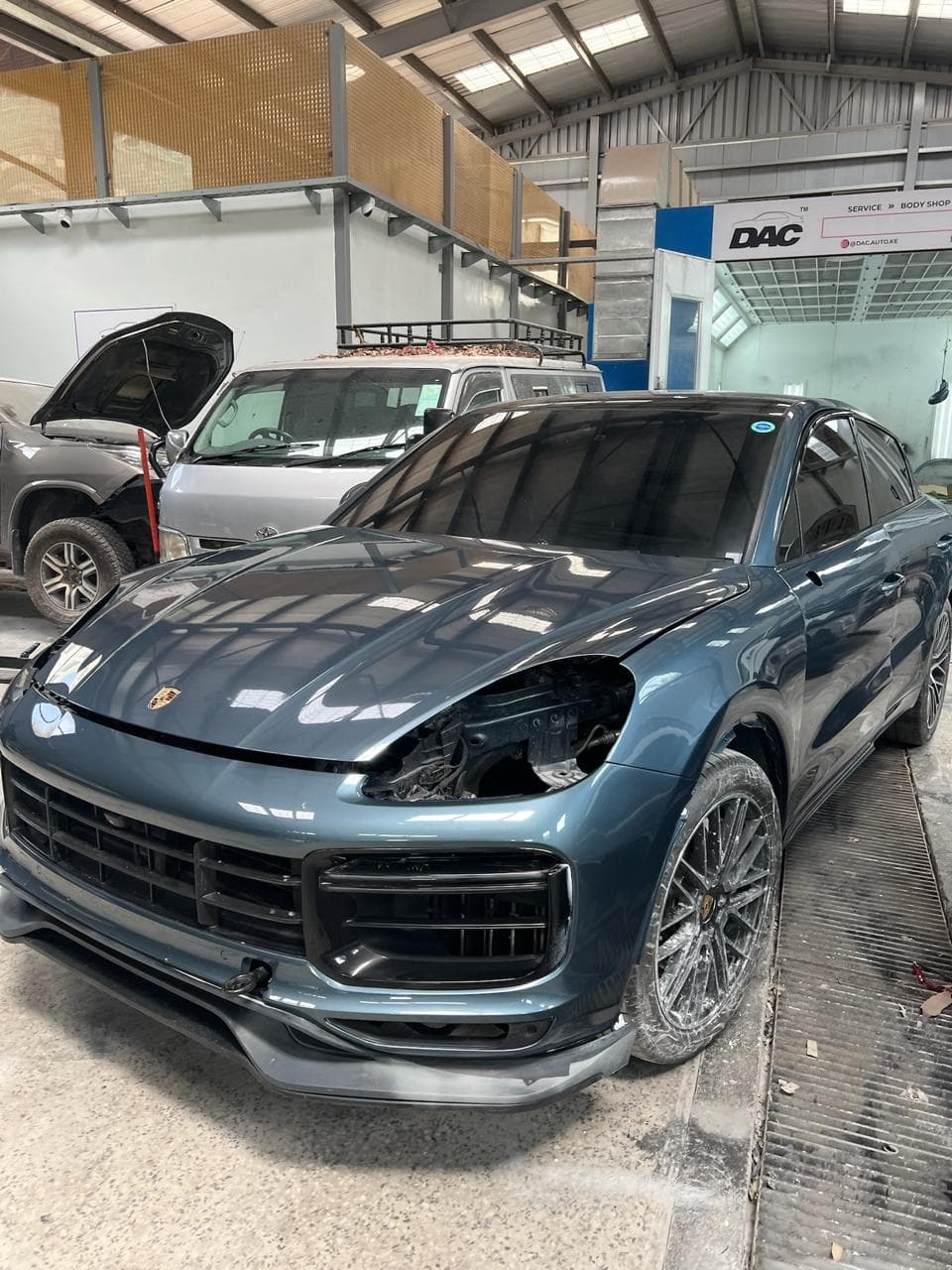 Automotive technician attending to a vehicle in the workshop